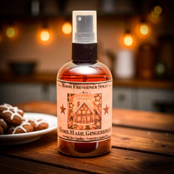 Homemade Gingerbread Room Spray 4 oz amber bottle with gingerbread house label and festive holiday kitchen background.