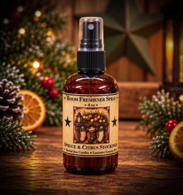 Spruce & Citrus Stockings 4 oz Room Spray in an amber spray bottle with a vintage Christmas stocking label, displayed on a rustic wooden table with festive greenery, pinecones, dried oranges, and warm holiday lights.