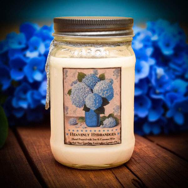 Heavenly Hydrangea 16 oz floral candle with a bright blue hydrangea label, featuring a soft, powdery scent.