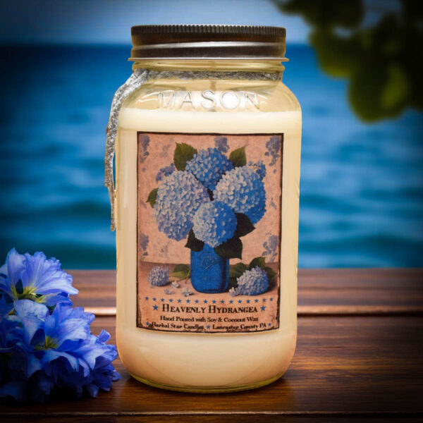 Heavenly Hydrangea 24 oz floral candle with a bright blue hydrangea label, featuring a soft, powdery scent.