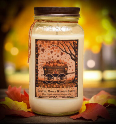 Falling Leaves 24 oz jar candle with folk art label of pumpkin wagon and falling autumn leaves