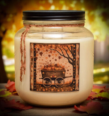 Falling Leaves 64 oz jar candle with vintage-style folk art label of a pumpkin wagon and autumn tree