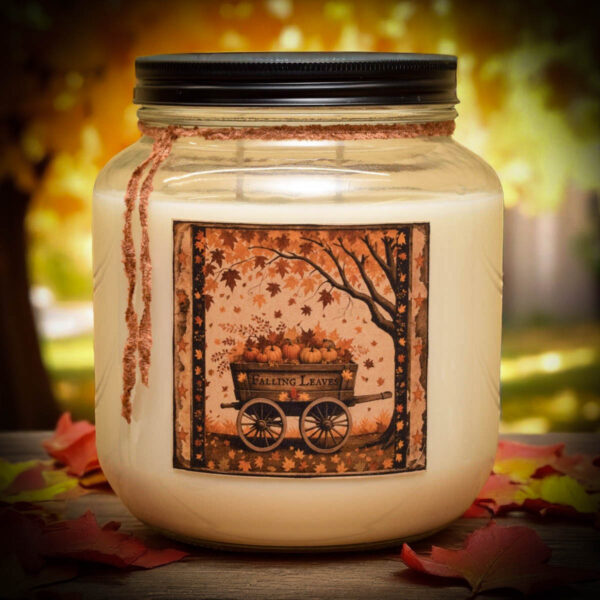 Falling Leaves 64 oz jar candle with vintage-style folk art label of a pumpkin wagon and autumn tree