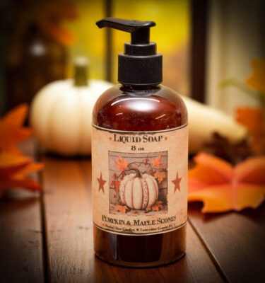 Pumpkin Maple Scones liquid hand soap in amber bottle with rustic autumn label, surrounded by pumpkins and fall accents.