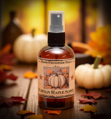 Pumpkin Maple Scones room spray in amber bottle with rustic label, set among fall decor and pumpkin treats.