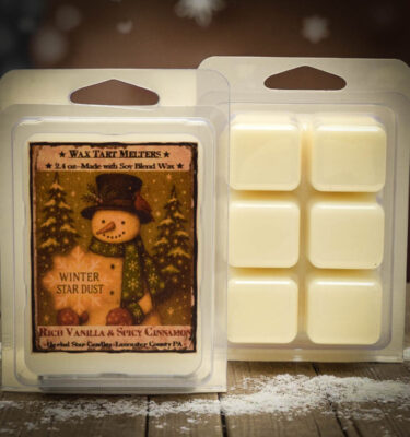 Clamshell pack of Winter Star Dust mini wax tart cubes with snowman label, scented with vanilla and cinnamon