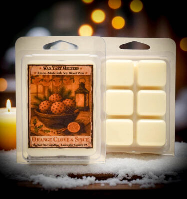 “Orange Clove Mini Tart clamshell with six wax squares and folk-art label, Herbal Star Candles, Lancaster County, PA”
