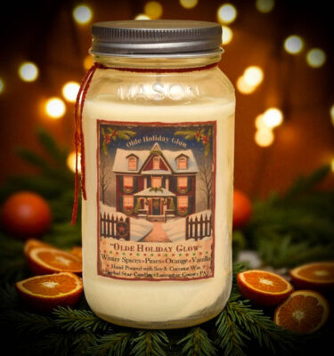 “Olde Holiday Glow 24 oz Christmas candle with festive label”