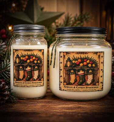 Spruce & Citrus Stockings 24 oz and 64 oz Soy and Coconut Wax Jar Candles displayed together on a rustic wooden table with festive evergreen greenery, pinecones, and warm Christmas lights.