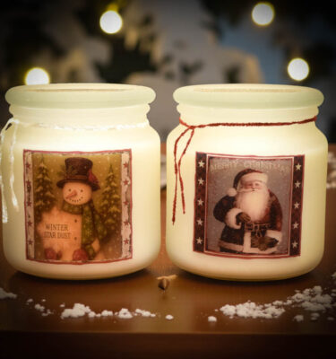 Christmas Season Apothecary Jar Collection featuring Winter Star Dust and Old Santa Cinnamon—18 oz frosted soy candles with folk-art snowman and Santa labels.
