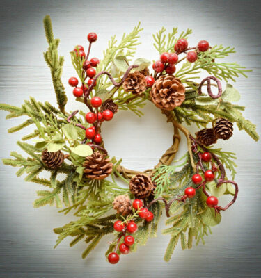 Holiday Eucalyptus Wreath with red berries, pinecones, and greenery