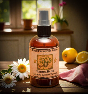 Lemon Daisy room spray bottle with creamy lemon biscotti fragrance, styled with lemons and daisies