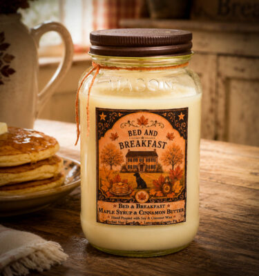 Bed and Breakfast 24 oz Candle with maple syrup and cinnamon butter fragrance displayed on a rustic farmhouse breakfast table with pancakes.