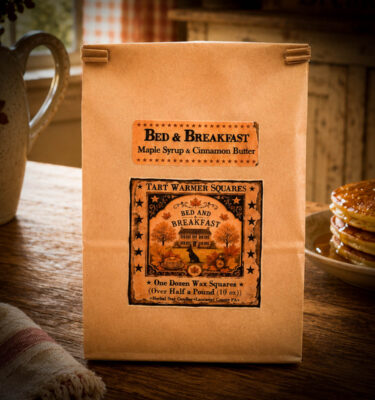 Brown kraft bag labeled Bed & Breakfast Tart Warmer Squares, 10 oz (12 squares), with folk art black lab, pumpkins, and autumn leaves.