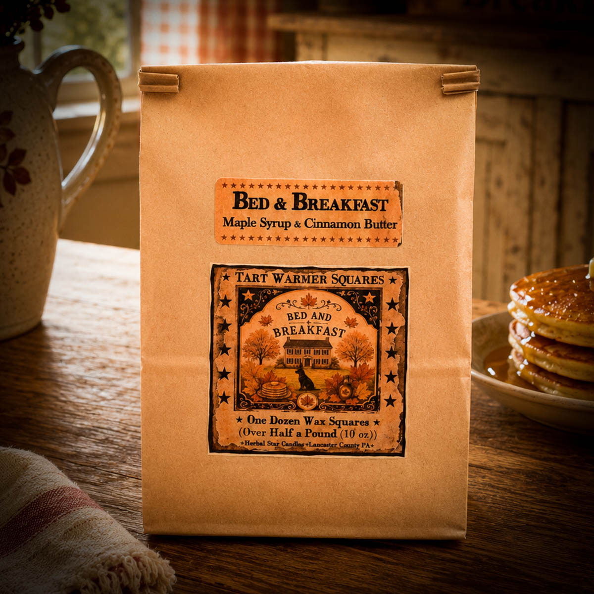 Brown kraft bag labeled Bed & Breakfast Tart Warmer Squares, 10 oz (12 squares), with folk art black lab, pumpkins, and autumn leaves.