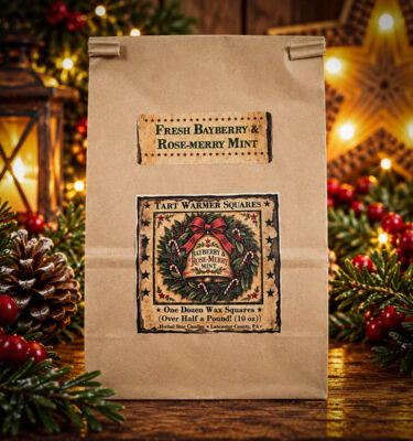 Herbal Star Candles Bayberry & Rose-Merry Mint 10 oz bag of 12 scented wax tart squares in rustic kraft packaging, displayed with festive rosemary and bayberry greenery.